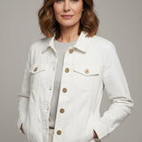 A white denim jacket with button closures and flap chest pockets, hanging on a black hanger in a clothing store.